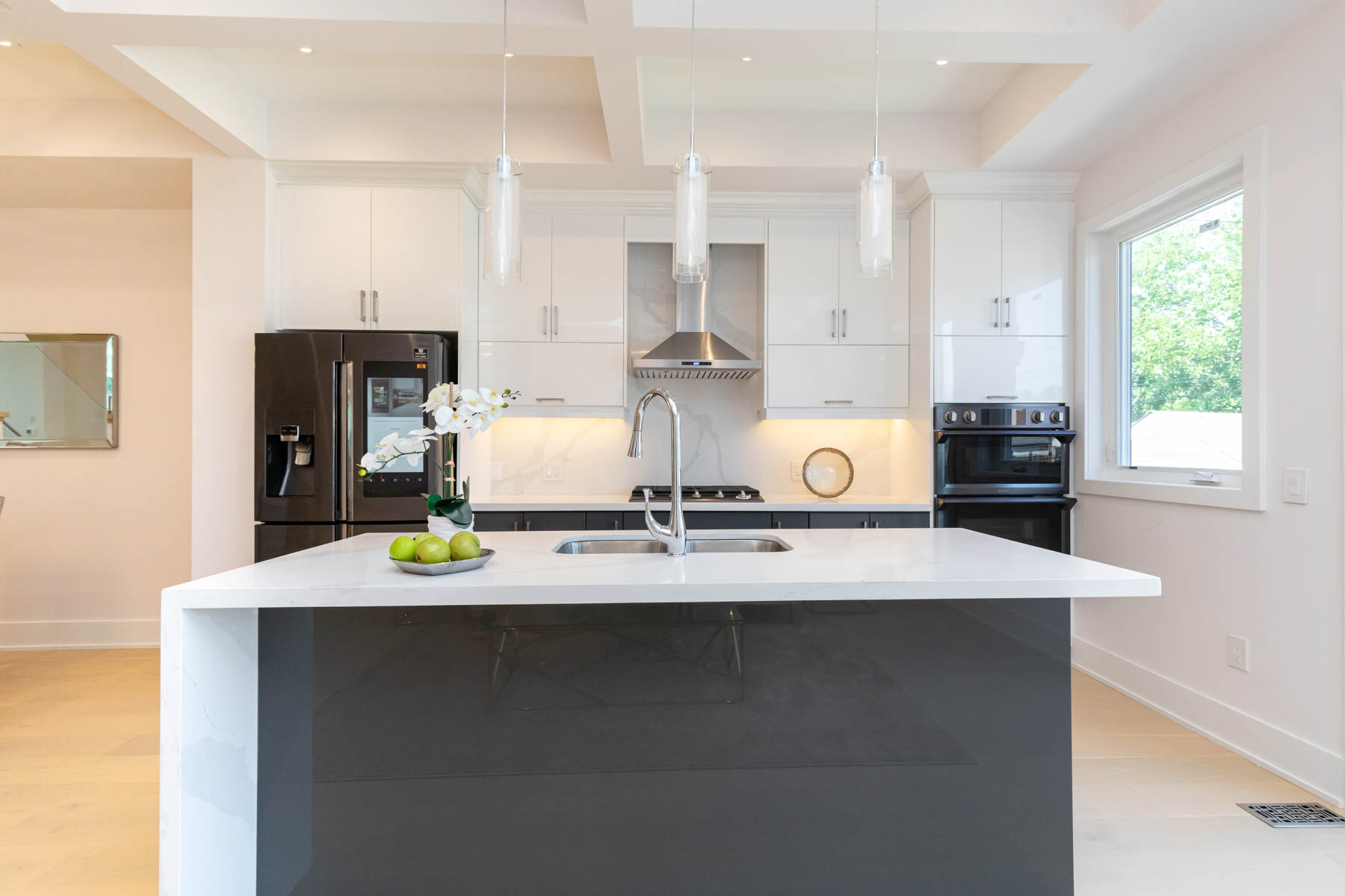 Bright modern kitchen with island inside a Toronto laneway suite