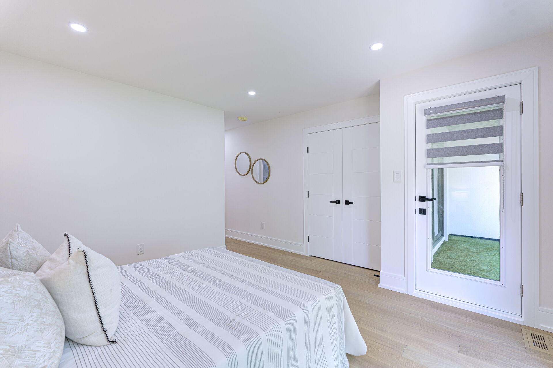 Light-filled bedroom with garden access inside a Toronto garden suite